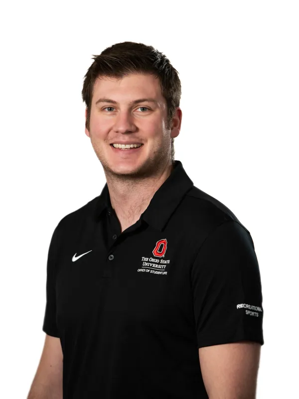 David Swearingen (Smiling person wearing a black OSU polo, against a white backdrop)